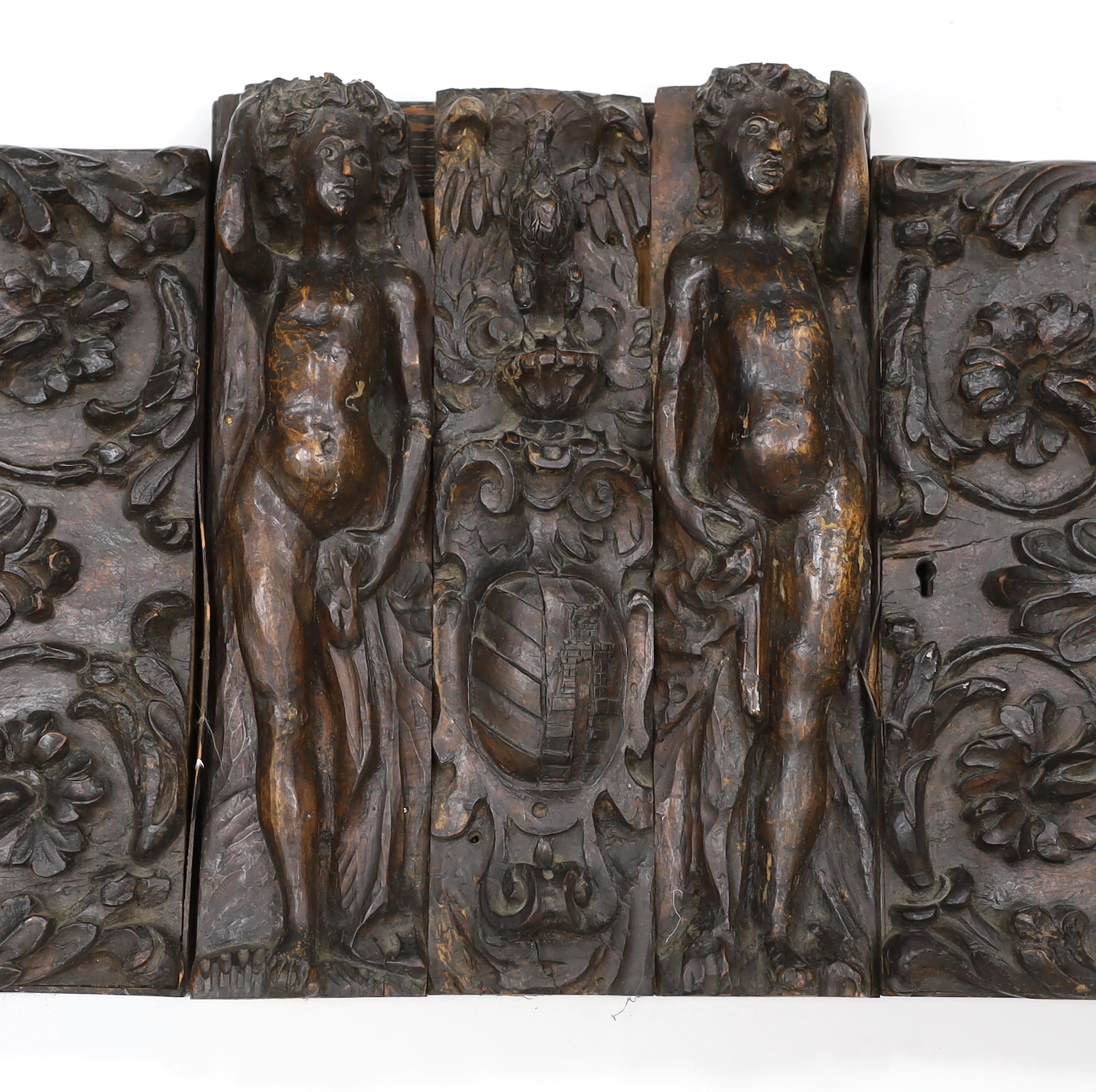 A 17th century French carved walnut triptych panel, 121cm wide, 37cm high